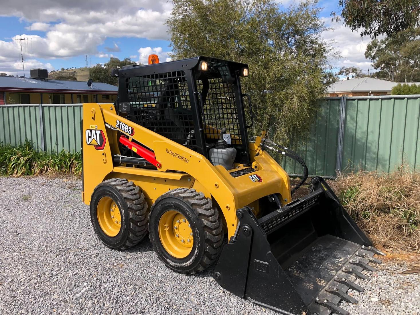 Jenko's compact loader and branded tipper truck near Boorowa