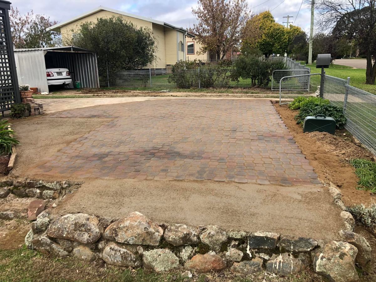 Worn old paved parking area before the work